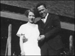 wedding couple in front of simple house