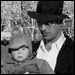 old photo of man carring small child